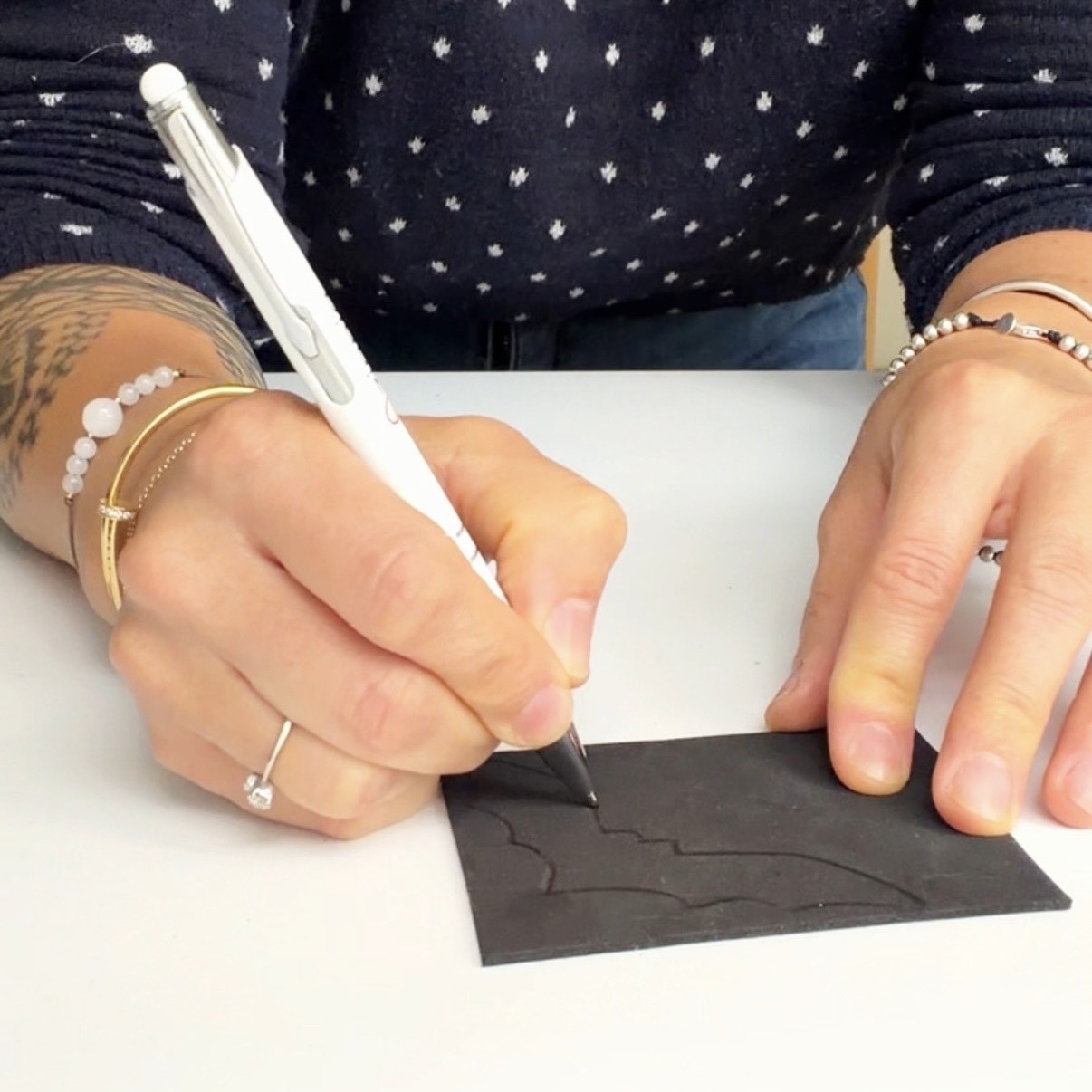 Trace a bat with a pen on a black foam sheet
