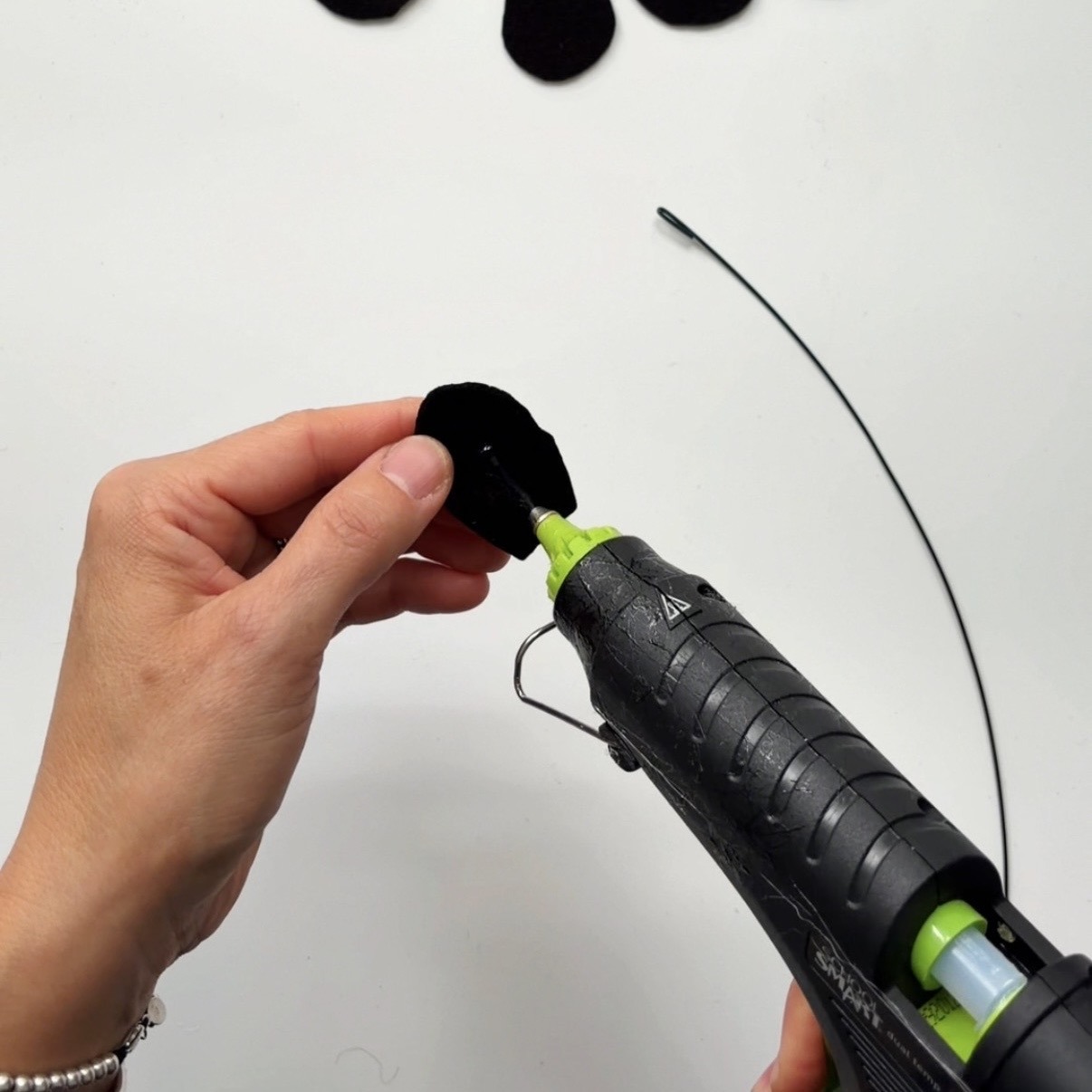 Put a dot of hot glue at the base of a petal
