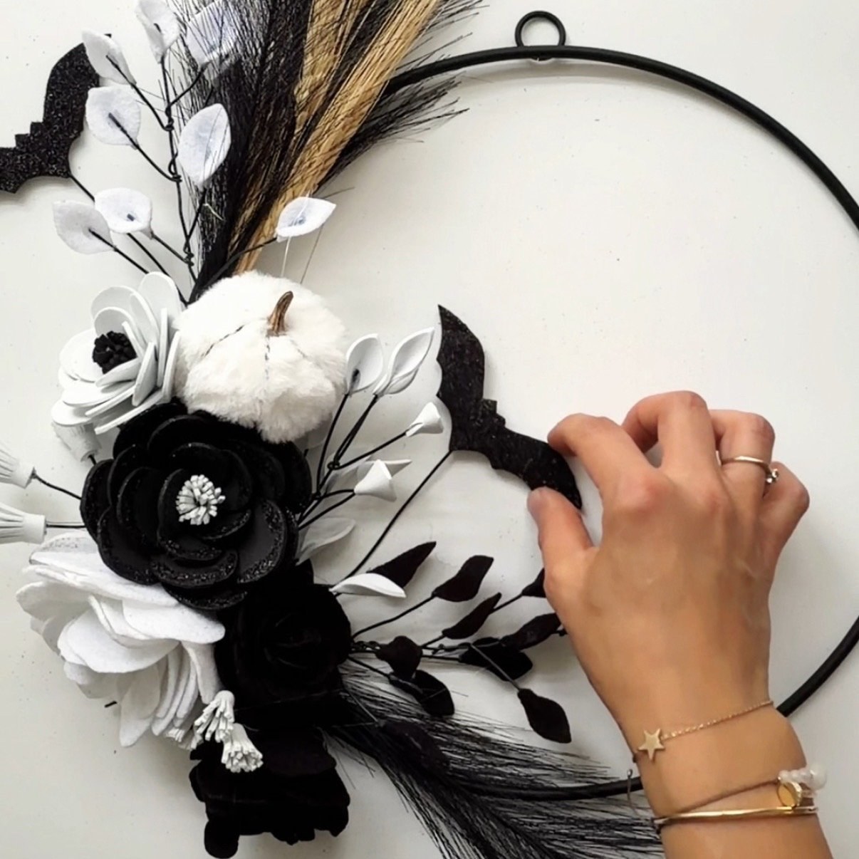 Adjust the position of the bats on the wreath