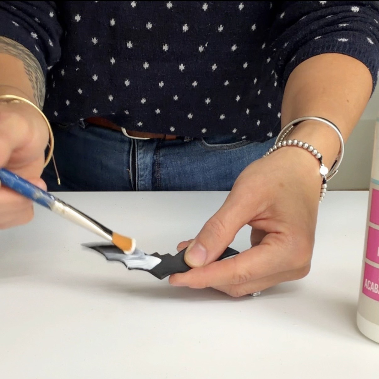 Brush the bat with white glue using the brush