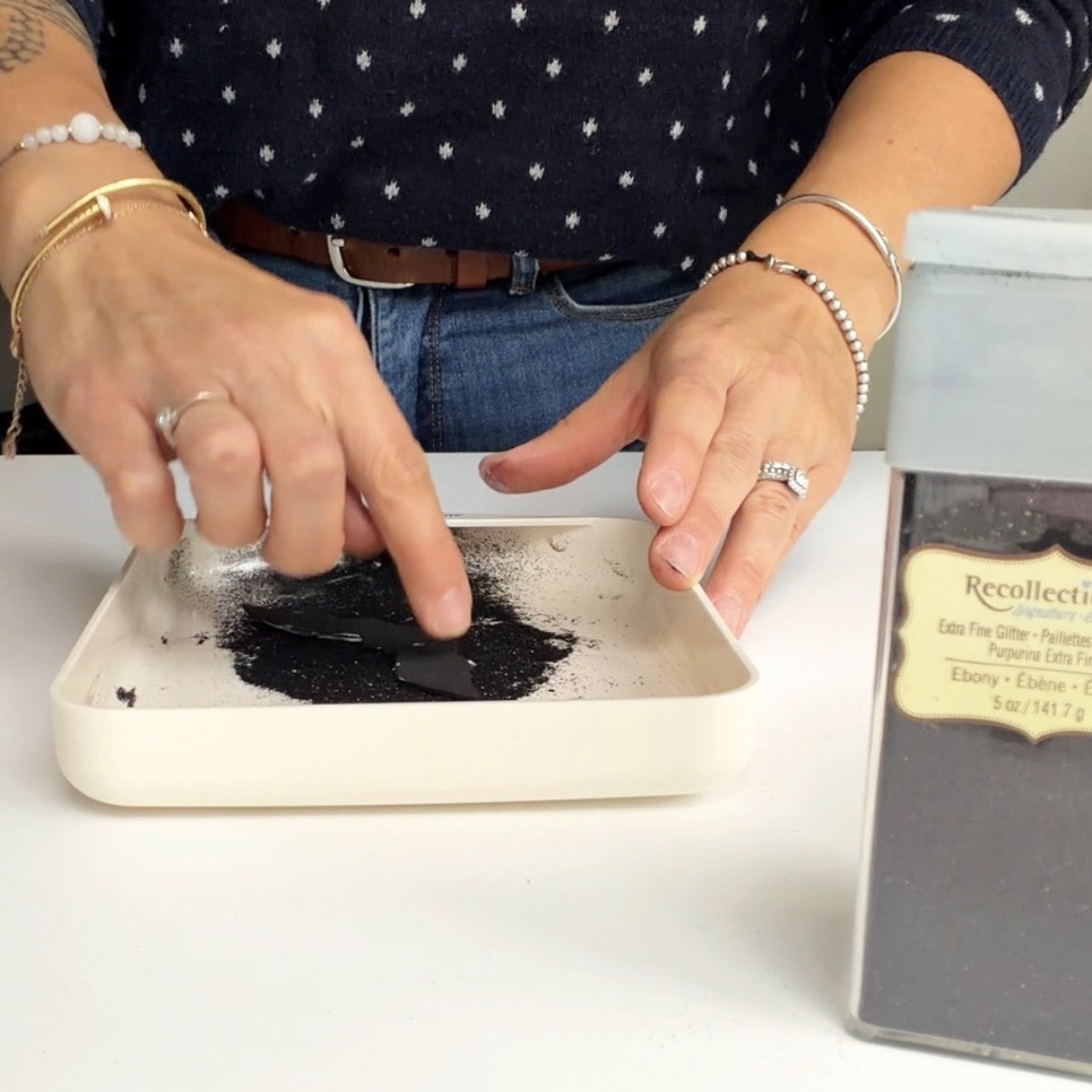 Place the bat into the black glitter